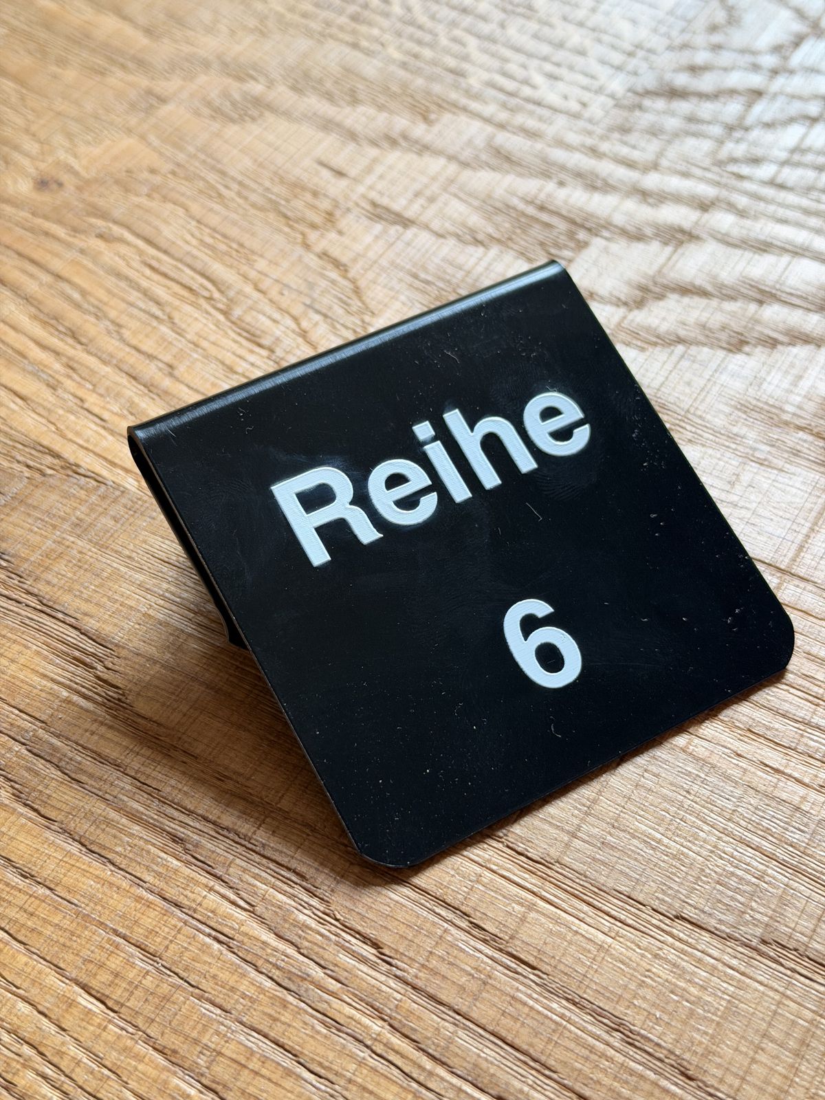 Black row sign “Reihe 6” (Row 6), made by woerner.systems